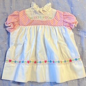 Vintage Polly flinders dress. Hand smocked with pink gingham sleeves. 12 months